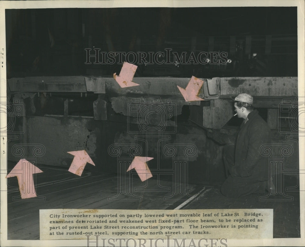  City Ironworker examines bridge - Historic Images