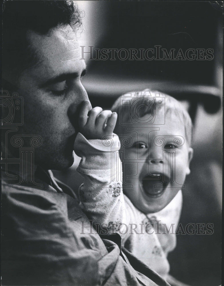 1968 A Mongoloid baby playing w/ his father&#39;s nose - Historic Images
