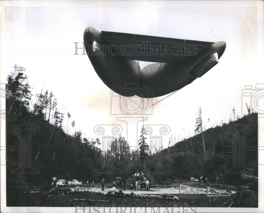 1965 Press Photo Logging Balloon Hovers Over Forests