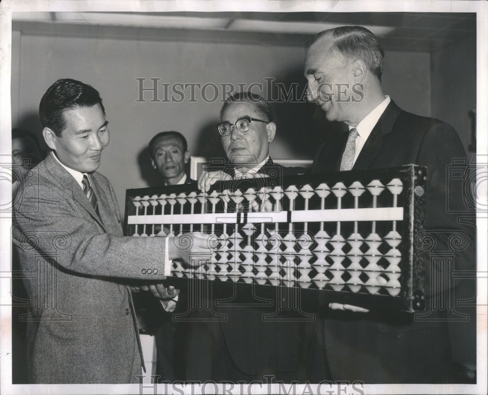 1962 Press Photo Japanese bankers shown with giant abac