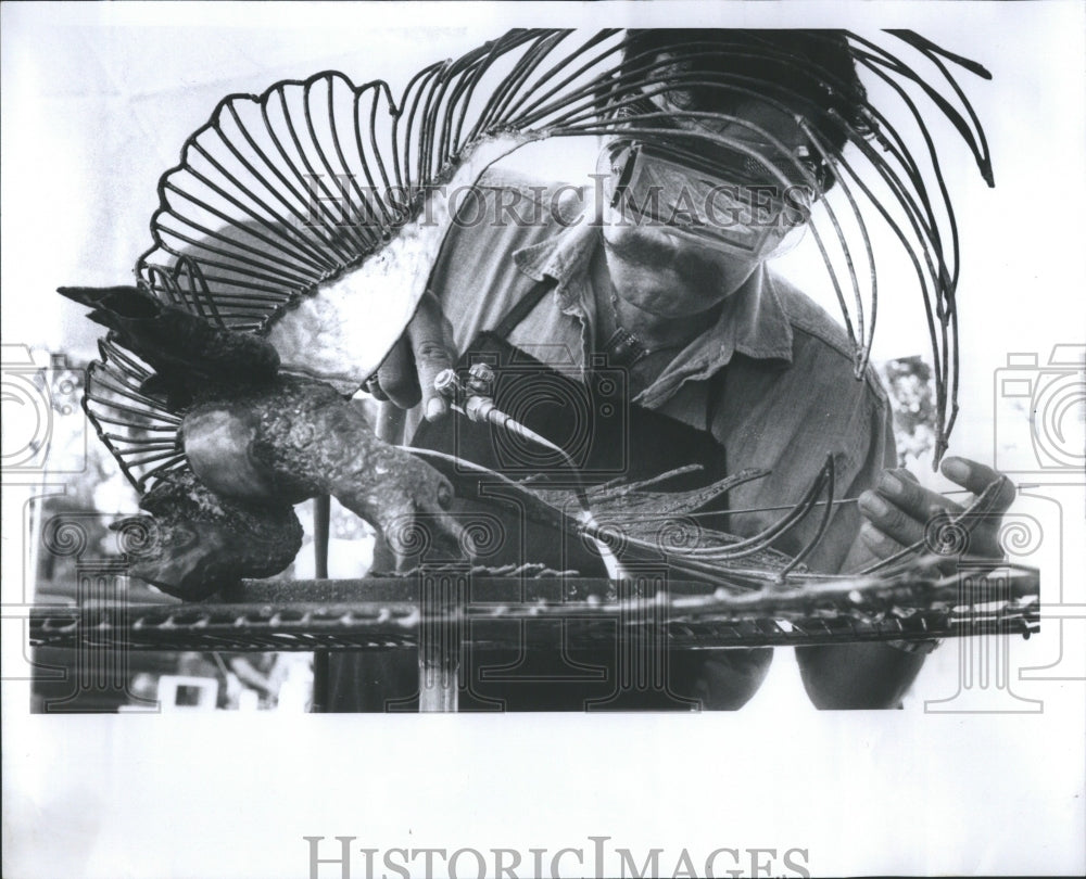 1978 Press Photo Torris welding a bird wing.