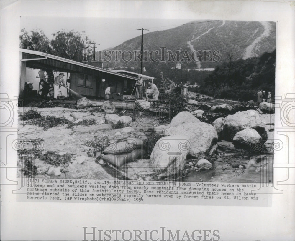 1954 Press Photo Boulders Mud Threaten Volunteer