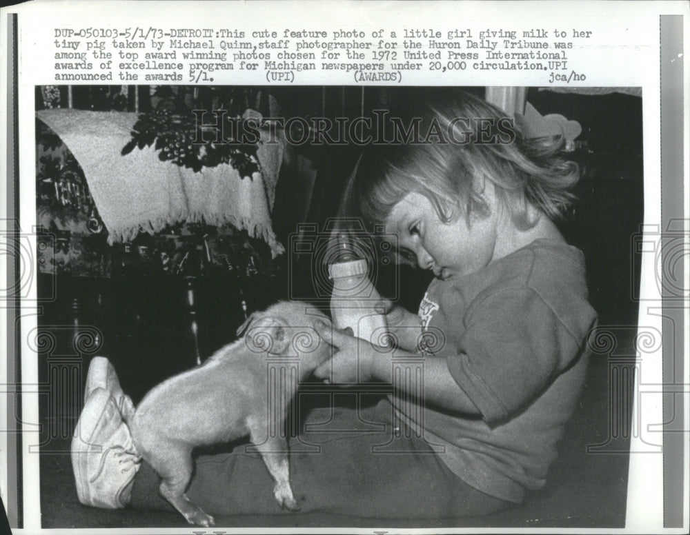 1973 Press Photo Little girl giving milk to her pig