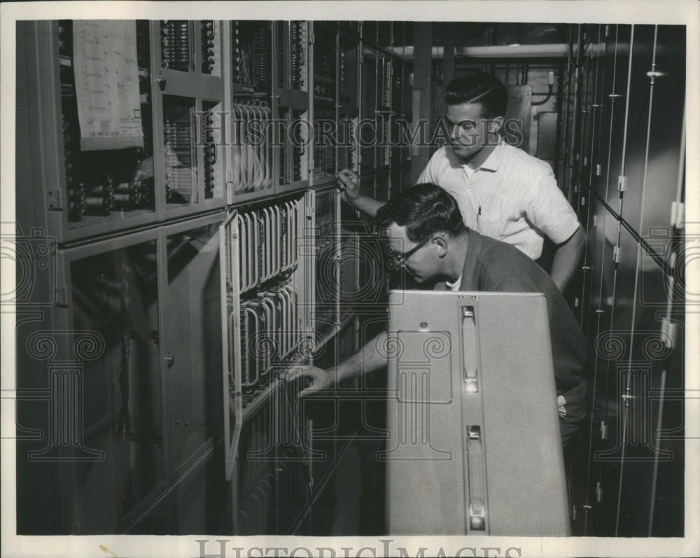 Press Photo Electronic technician check rack circuits