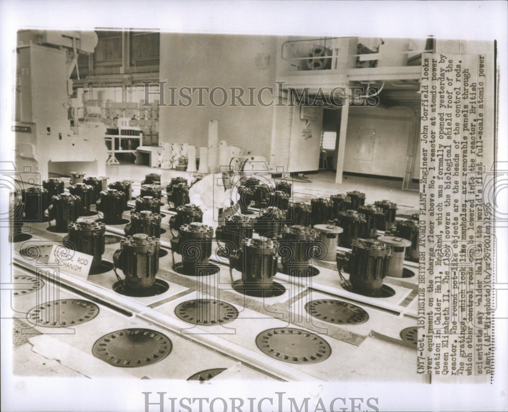 1956 Press Photo Engineer Corfield look over equipment