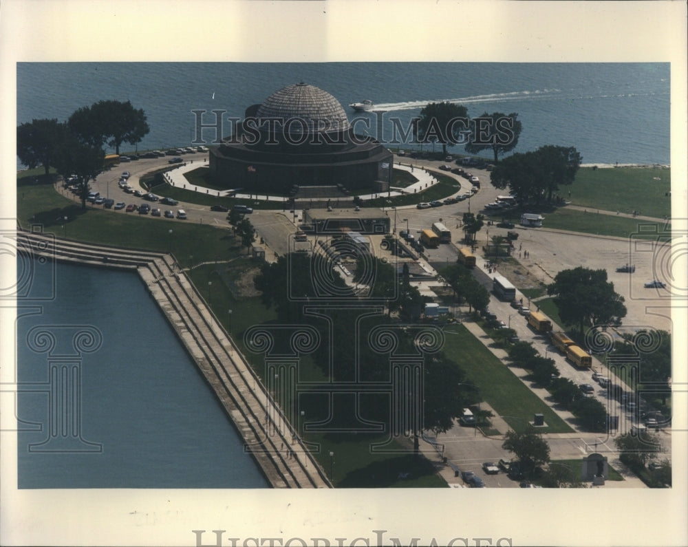 Press Photo Circular Building Near Water Busses Parked