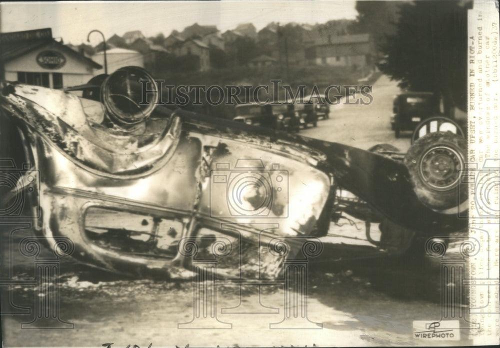 1937 Press Photo Police car set on fire during riot.