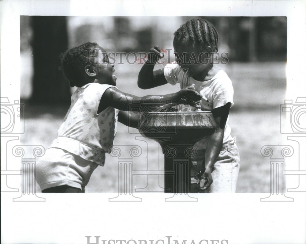 1988 Press Photo kids playing with the water fountain.