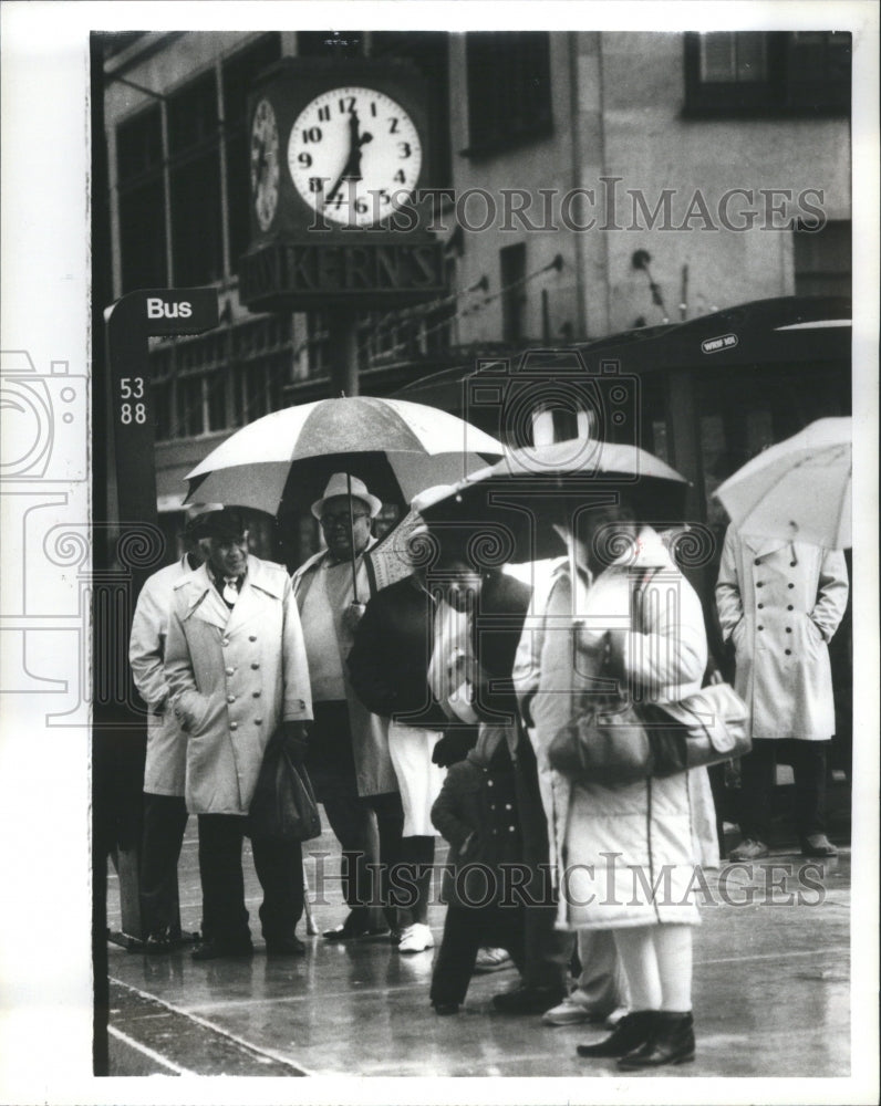 1984 Press Photo People Street Corner Raining Umbrellas