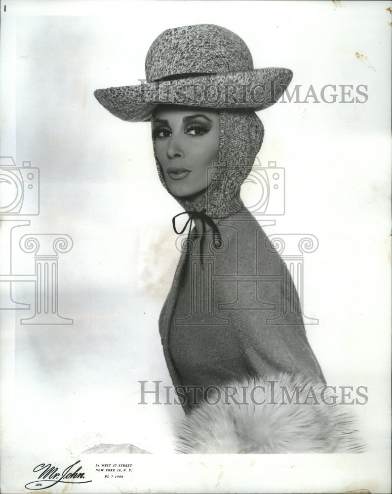 1965 Press Photo Accessoory Head Hat Reason Safety