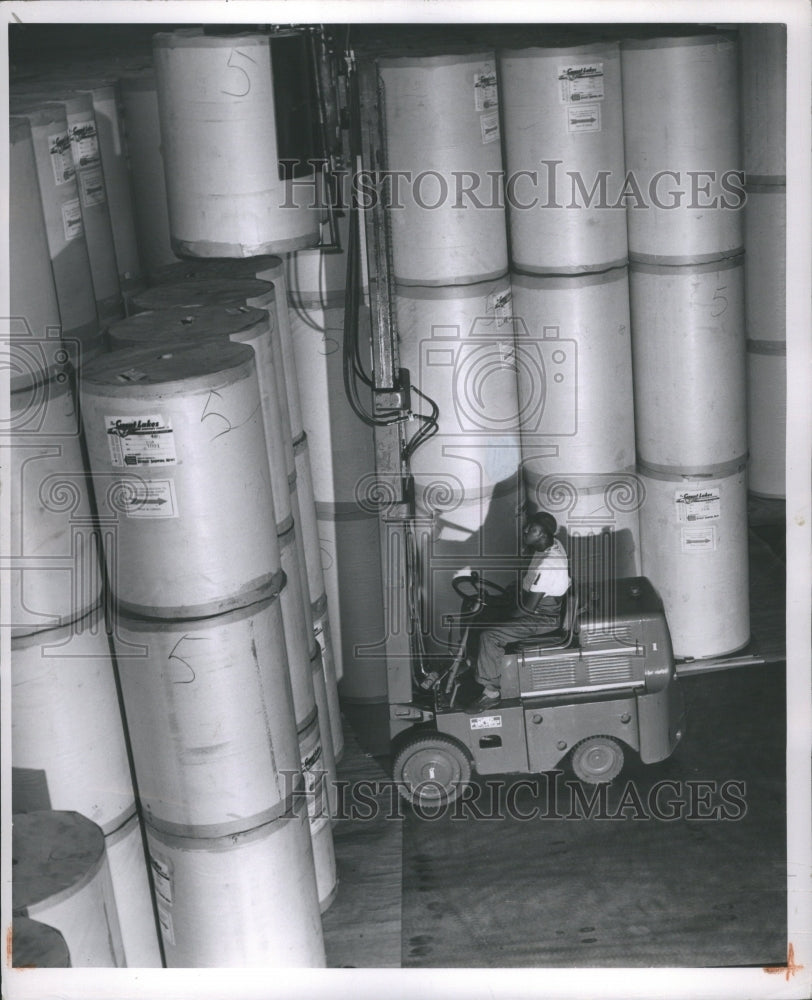 1949 Press Photo Detroit Times Warehouse Stacking Rolls