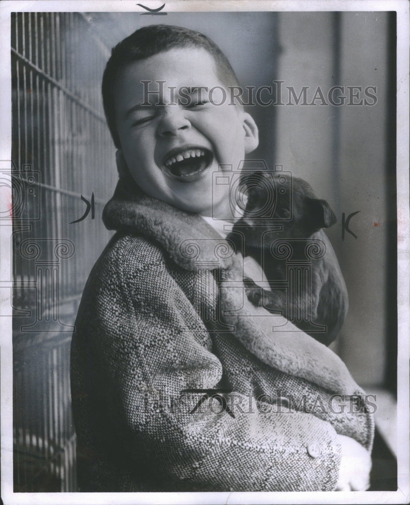 1956 Press Photo Boy Holding Puppy Laughing