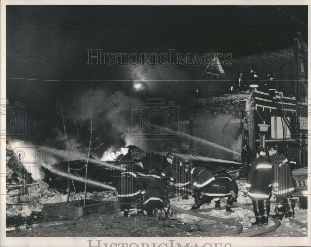 1984 Press Photo Firefighters pour water on fire