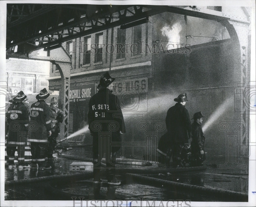 1975 Press Photo Firemen Roof Poke Water Marshal Thomas