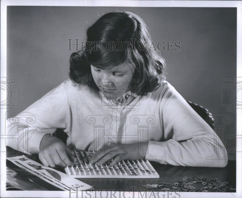 1956 Press Photo Girl makes picture with pegged board