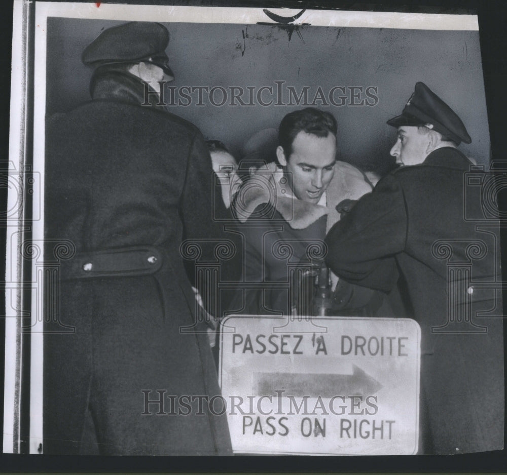 1955 Press Photo Officers try to hold back gate crasher