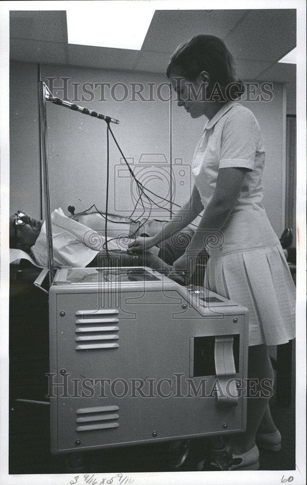 1969 Nurse Runs Diagnostic Test On Patient - Historic Images