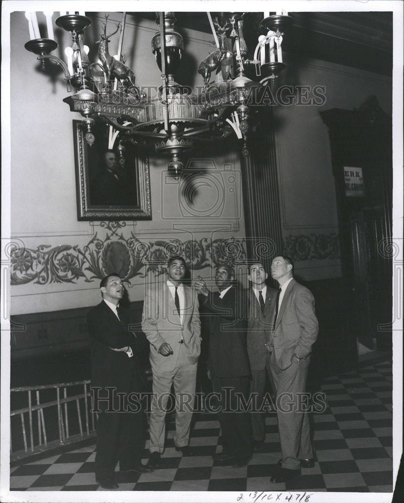 1959 Men view 500 lb. antique chandelier - Historic Images