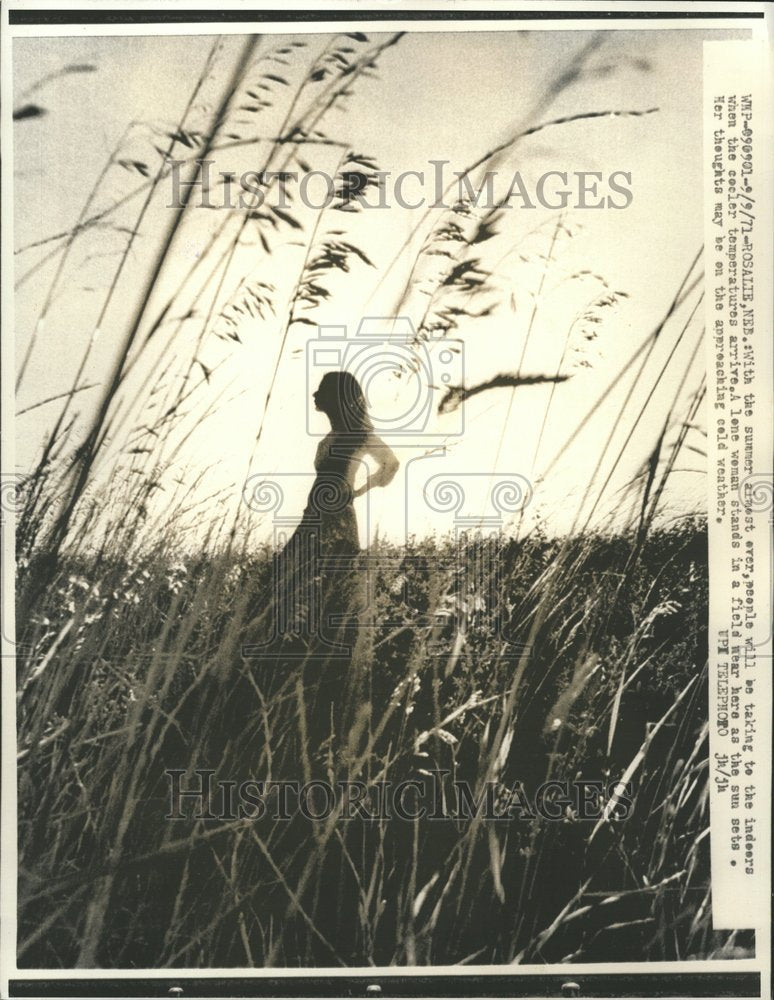 1971 A Lone woman stands in a Field - Historic Images