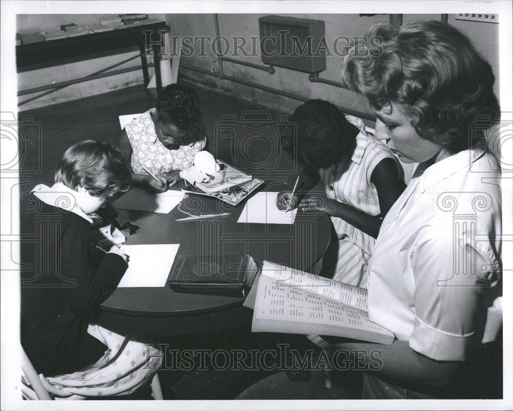 1962 Teacher gives spelling test to student - Historic Images