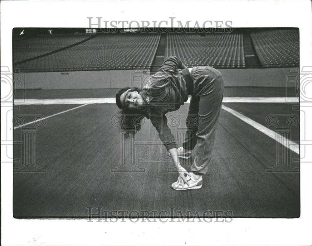 1982 Tracksuit Model in Gym Bending Over - Historic Images