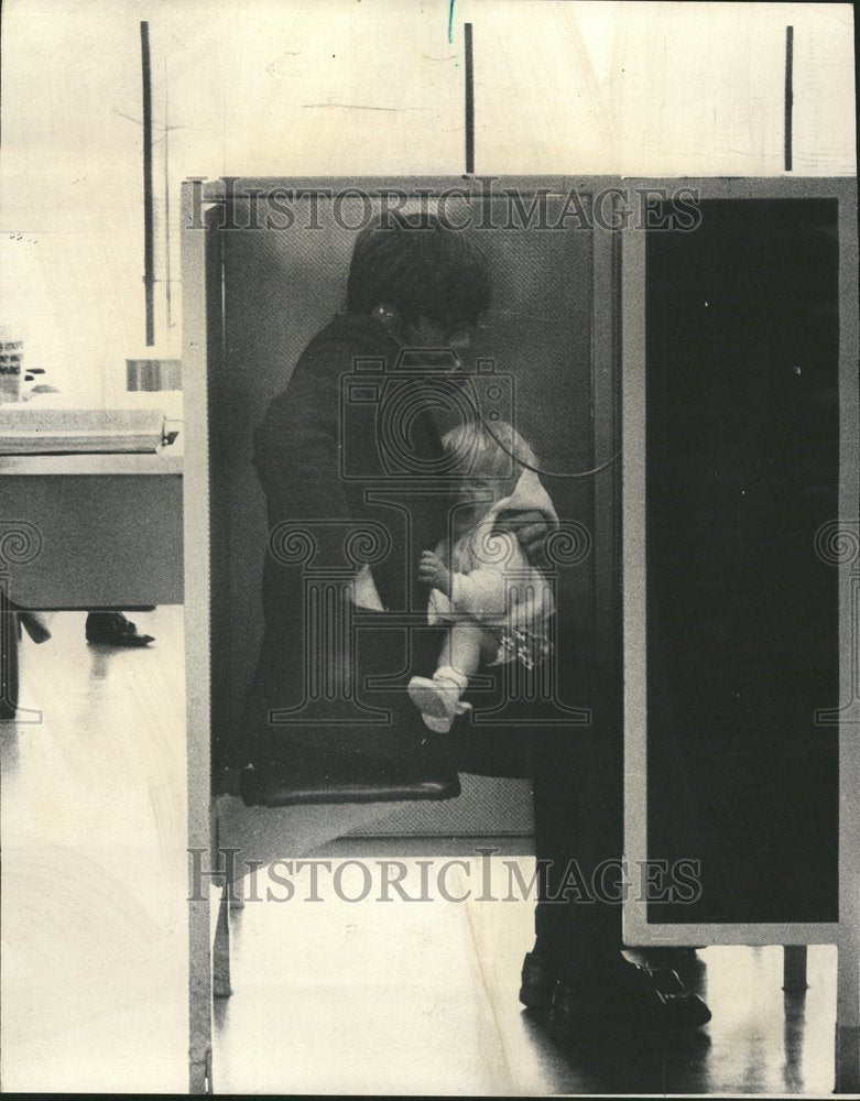 1973 Attempted Phone Booth Call with Baby - Historic Images