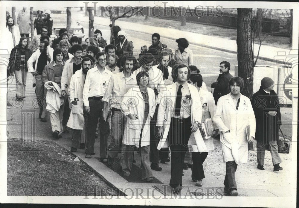 1976 Doctors walk down corridor to Director - Historic Images