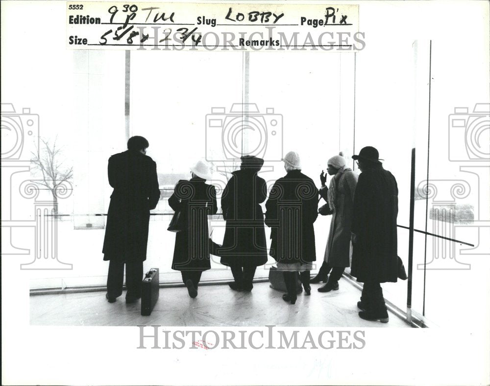 1984 Coated People Look Out Building Window - Historic Images