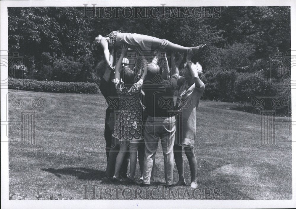 1970 Group Holds Woman Up In Trust Game - Historic Images