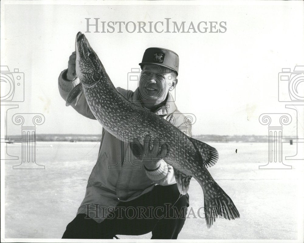 1970 Man Catches Huge Pike Ice Fishing - Historic Images