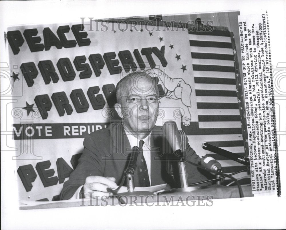 1956 Harold Stassen sits before slogan - Historic Images