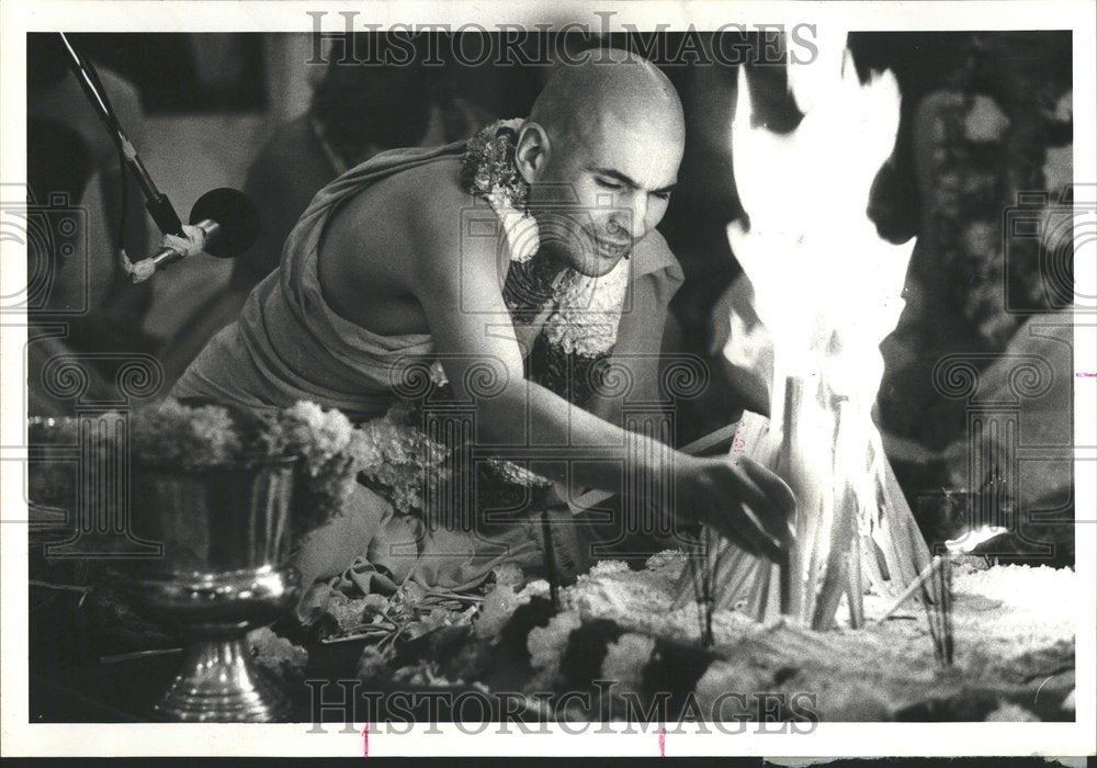 1979 Swami tends ritual fire - Historic Images