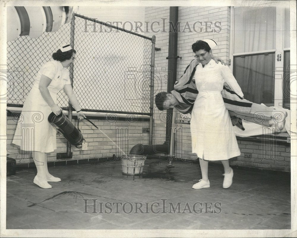 1956 Nurses give a fire drill demonstration - Historic Images