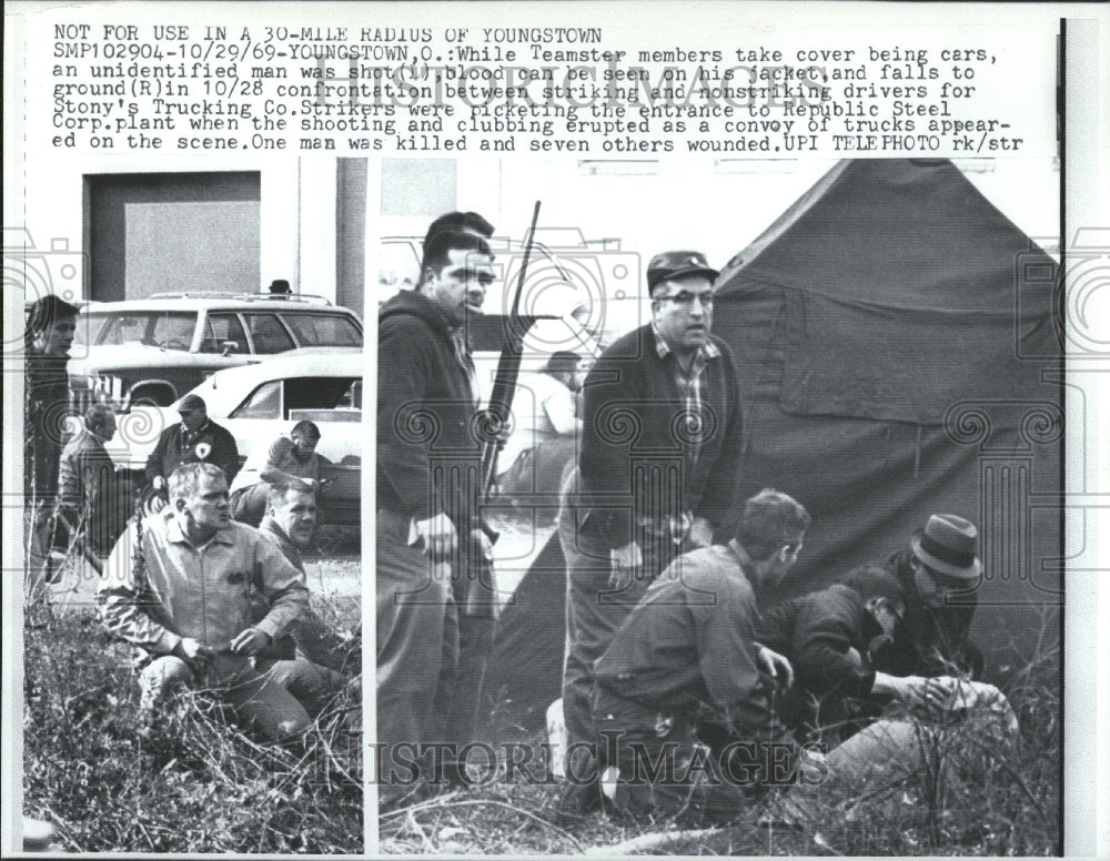 1969 Teamster members take cover being cars - Historic Images