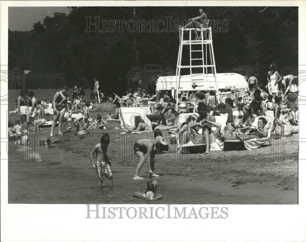 1987 Lifeguard John Bahura in his post at Cass Lake Oakland county - Historic Images