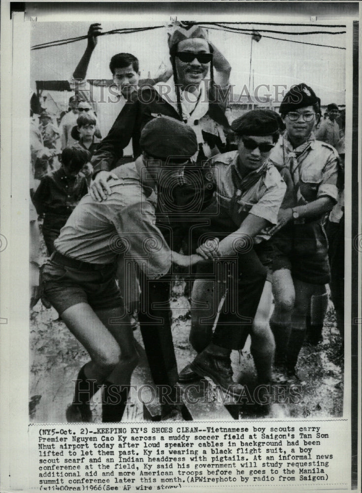 1966 Scouts carry Ky across muddy field - Historic Images