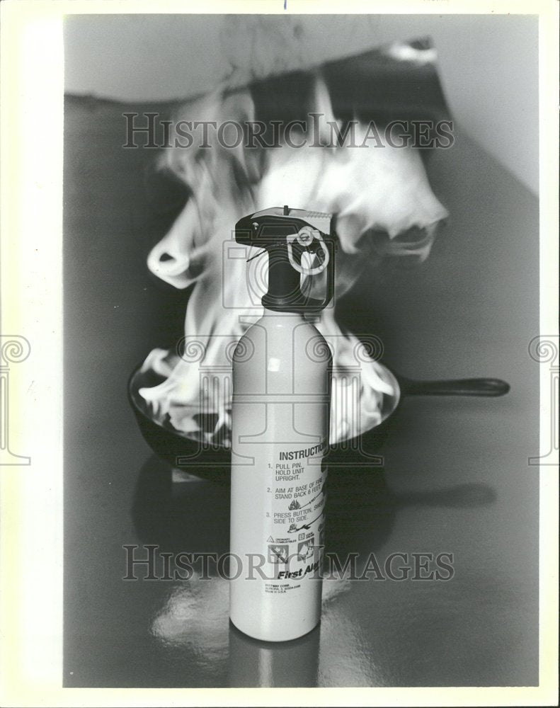 1986 Fire Extinguisher With Flaming Skillet - Historic Images