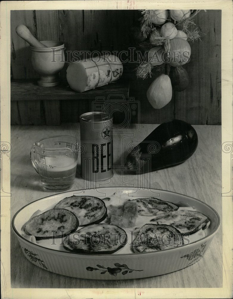 1986 Eggplant Casserole Display With Beer - Historic Images