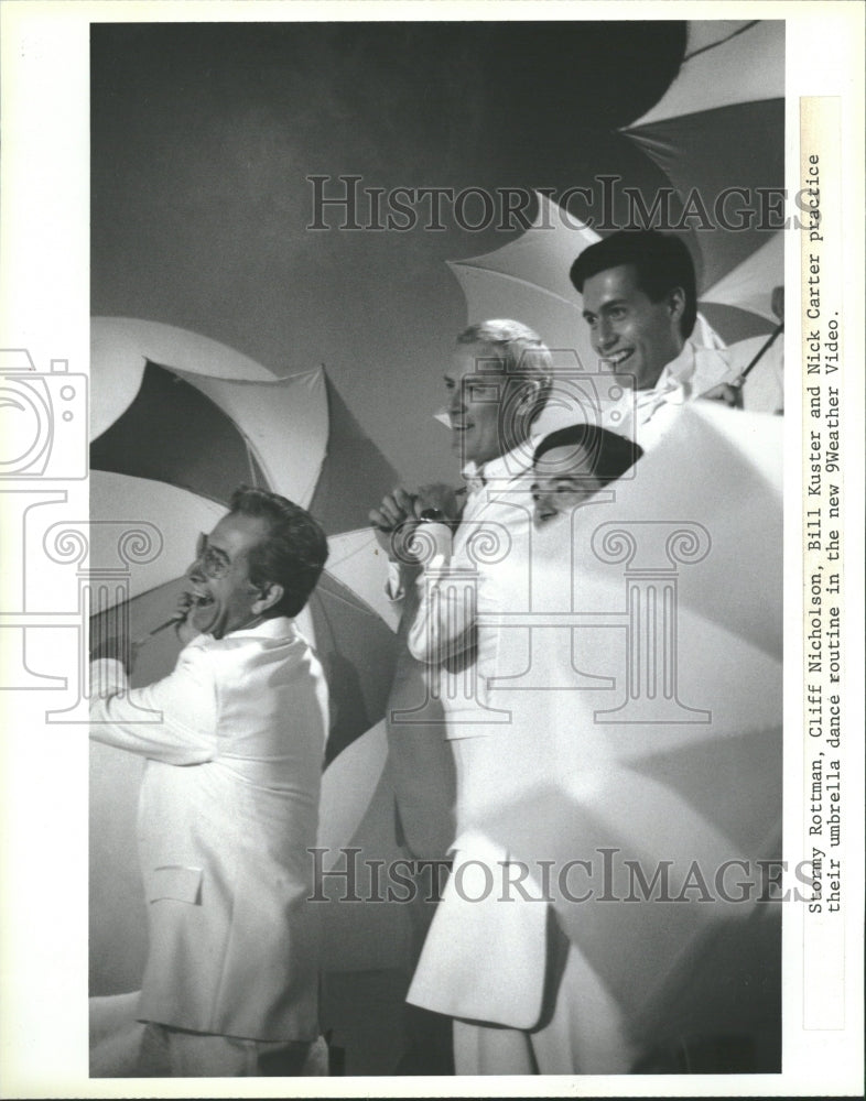 1986 Weather men umbrella dance routine - Historic Images