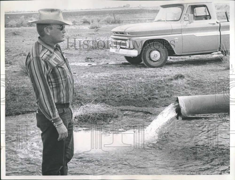 1966 RE Finley Jr. Inspects Irrigation Pipe - Historic Images