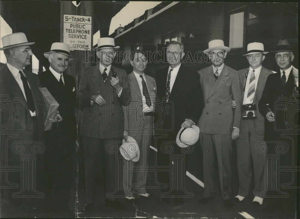 1937 Group of businessmen standing by sign - Historic Images