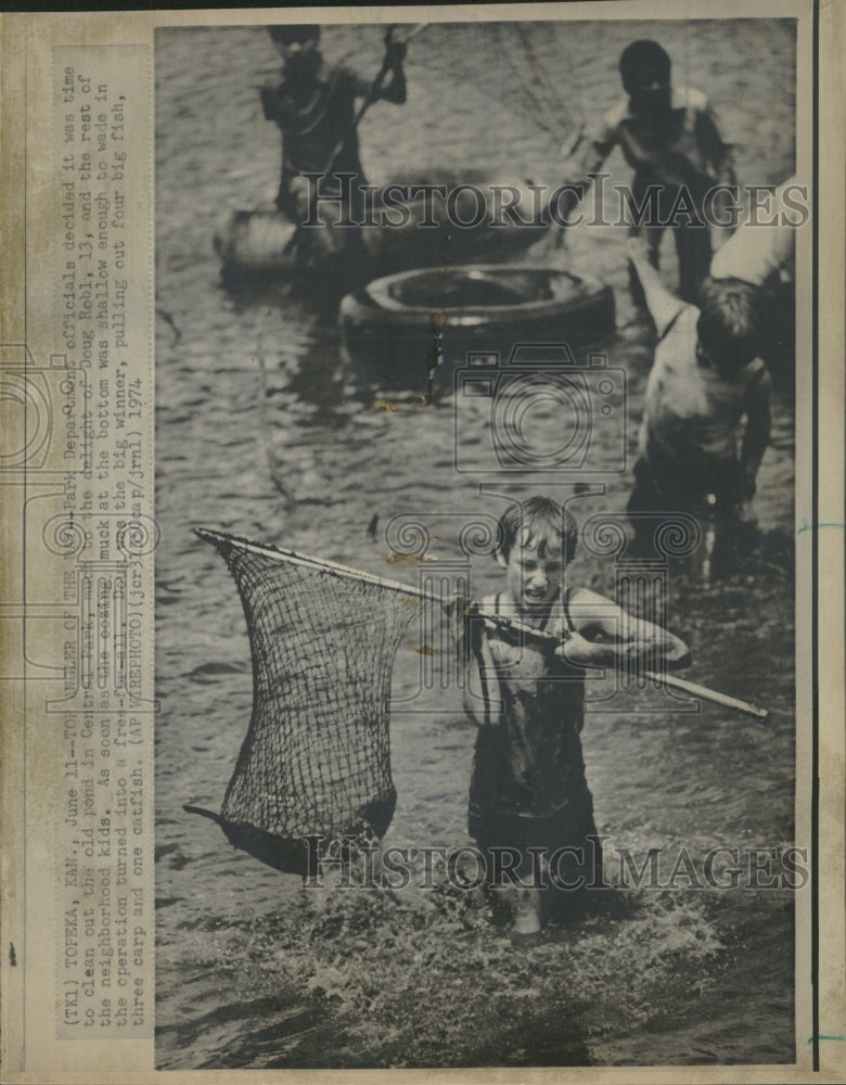 1974 Doug Robl, 13, catching fish - Historic Images