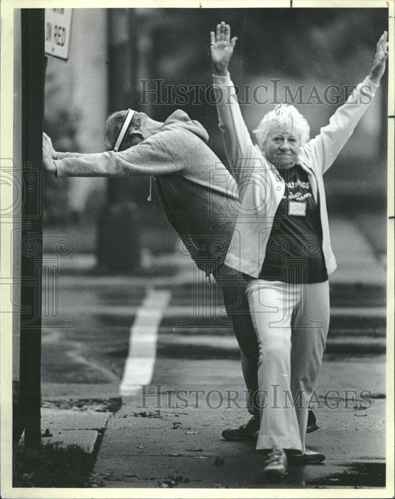 1984 Seniors Stretching Before Race - Historic Images