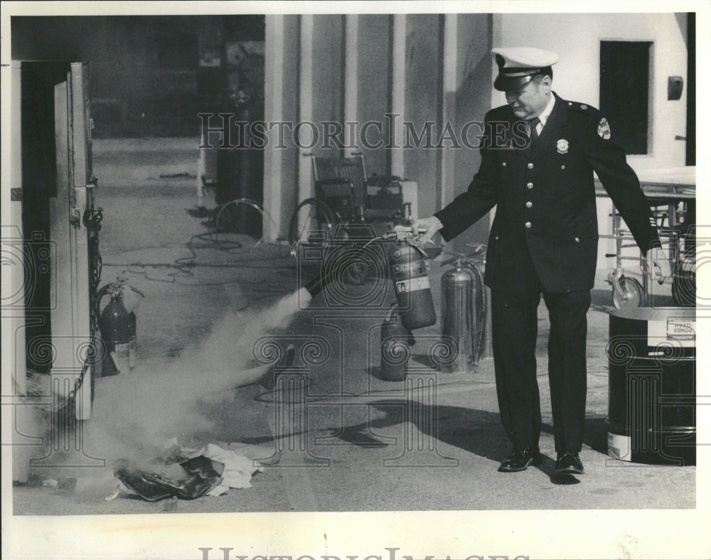 1986 Fire fighter evacuation extinguisher - Historic Images