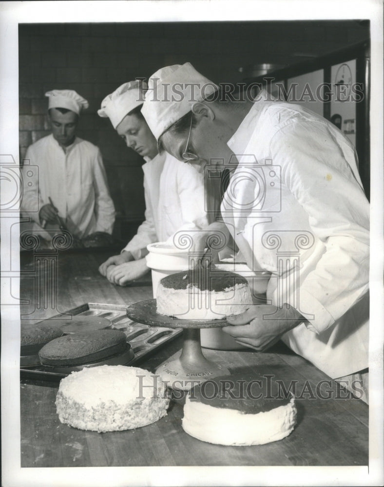 1941 Student bakers spread icing on product - Historic Images