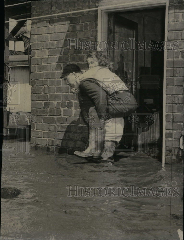 1950, Man Rescues Family Member - RRU49807 - Historic Images