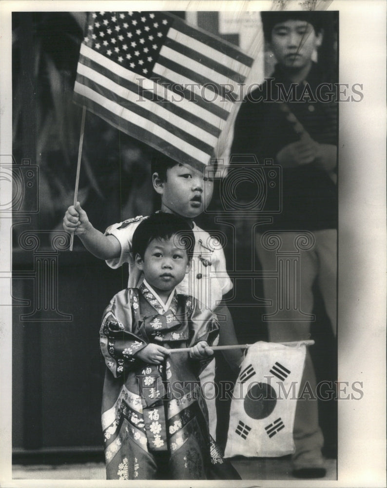 1984 Press Photo Bryant Kim Korean Parade Flags Bess - RRU73259 - Historic Images