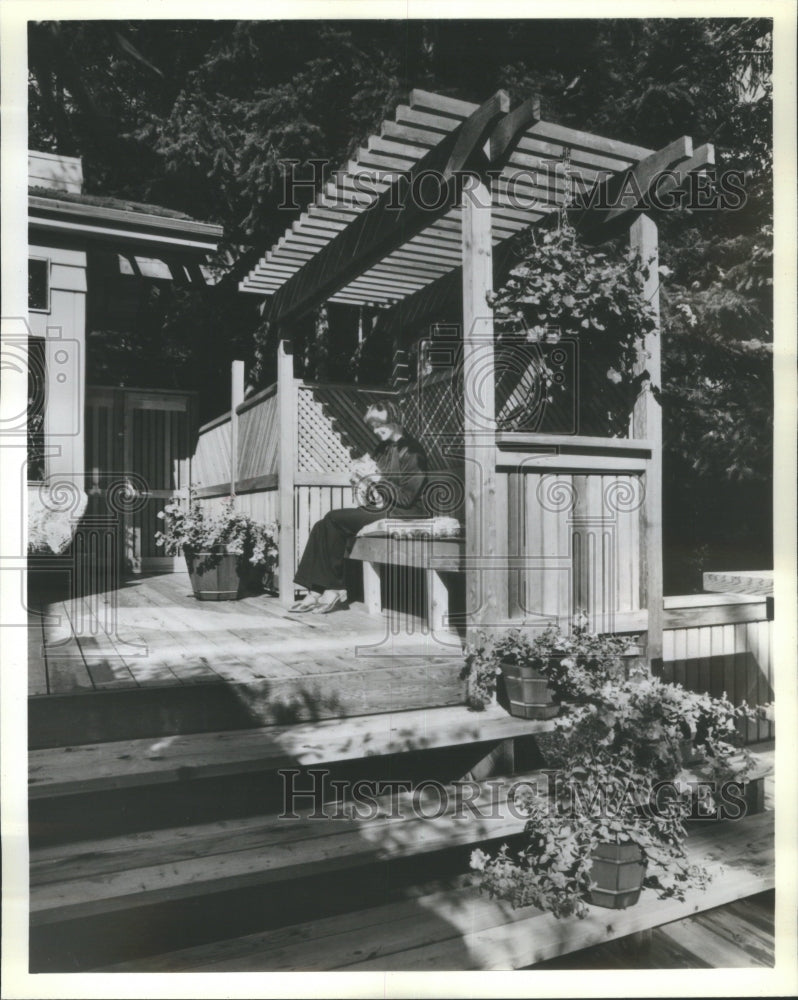 1981 Press Photo Wooden Porch Woman Knitting Awning - RRU77451 - Historic Images