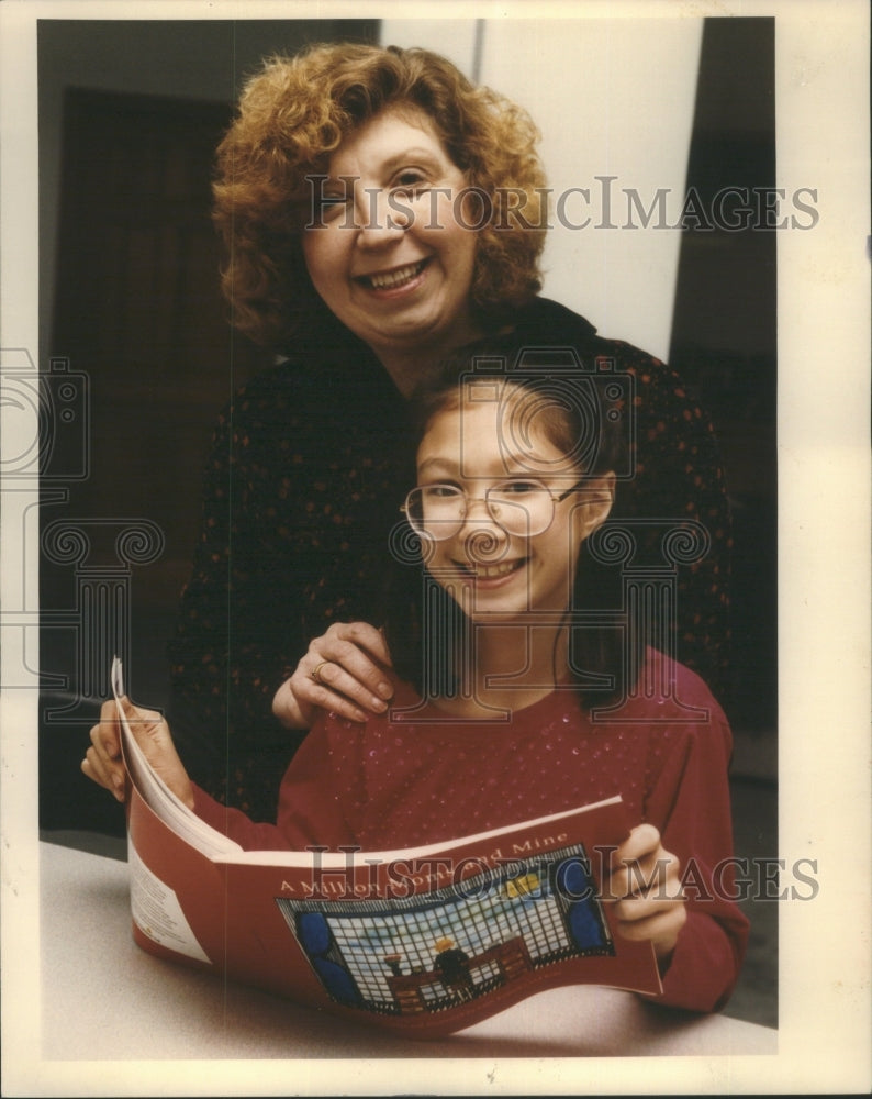 1992 Working Mother With Child Reading Book  - Historic Images