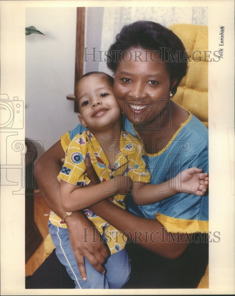 1990 Single Mother Holding Child Savings - Historic Images